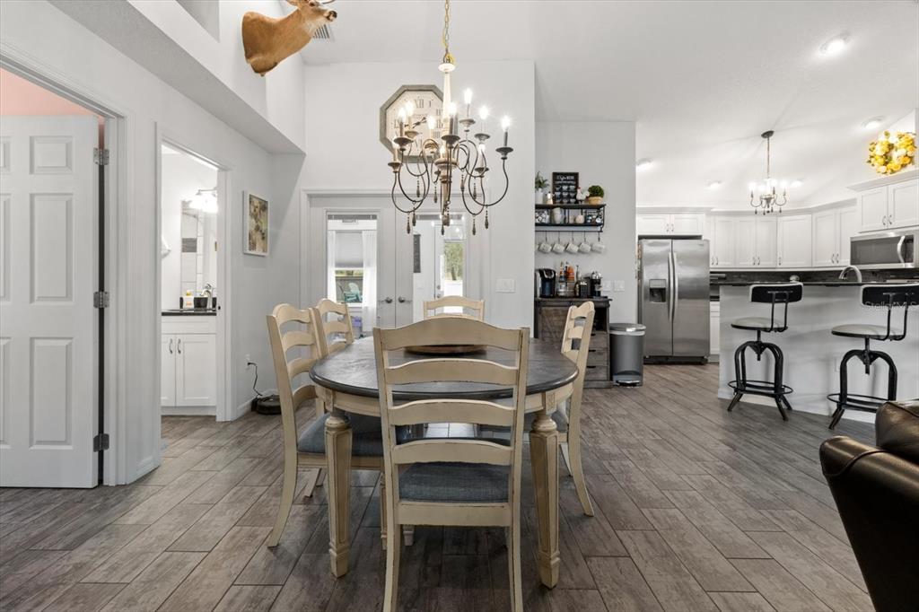 5317 West Tortuga Loop Lecanto, FL 34461 - Photo 10 of 37 a view of a dining room with furniture and chandelier