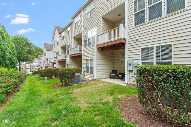 a view of a house with backyard and sitting area
