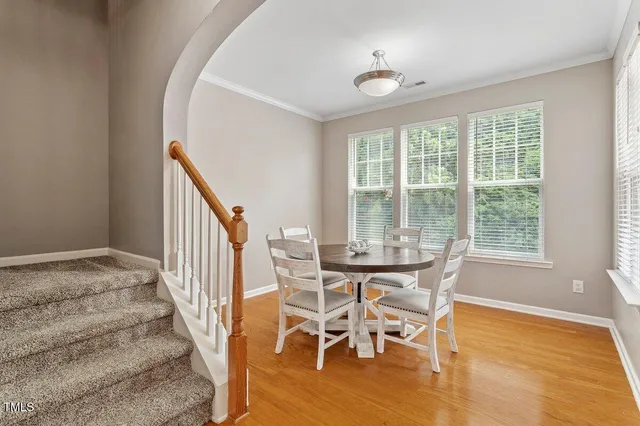 a view of a dining room with furniture window and wooden floor