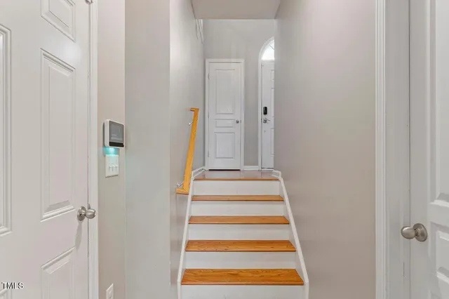 a view of a bedroom with a fireplace and door
