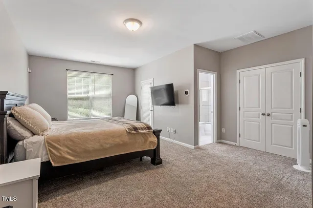 a bedroom with a bed and window