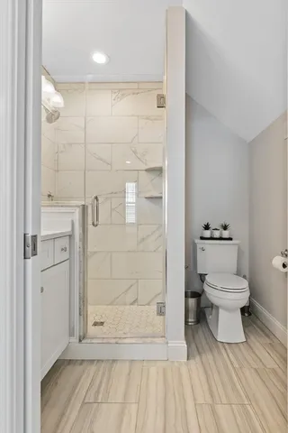a bathroom with a toilet and a shower