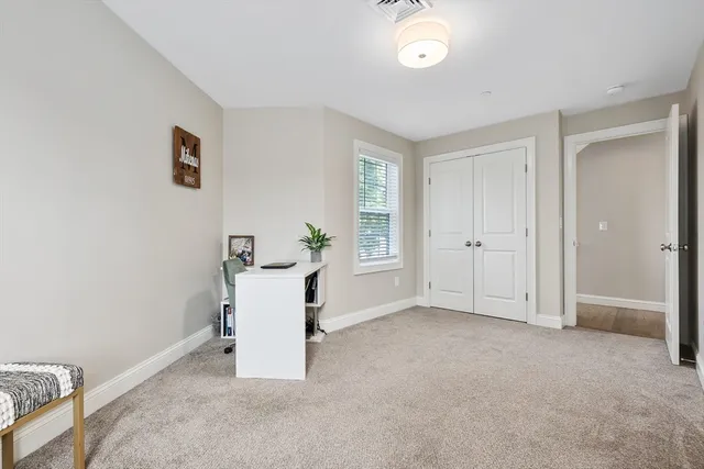 a livingroom with workspace and a window