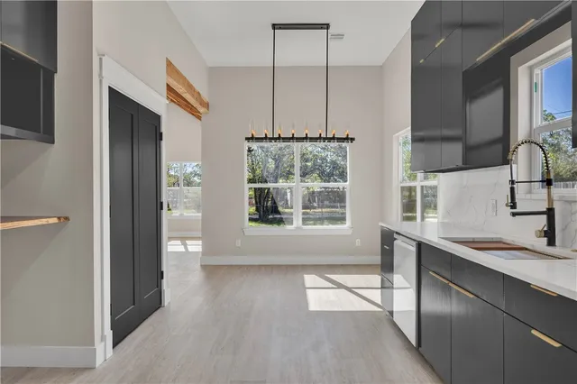 a kitchen with stainless steel appliances a sink stove and cabinets