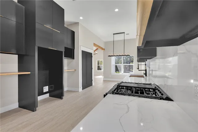 a kitchen with stainless steel appliances a refrigerator and a stove