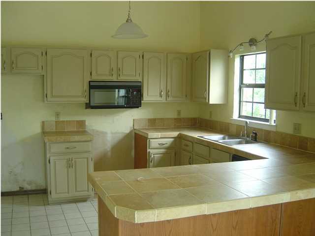 2518 Valley Road Navarre, FL 32566 - Photo 3 of 8 a kitchen with a sink and a stove top oven