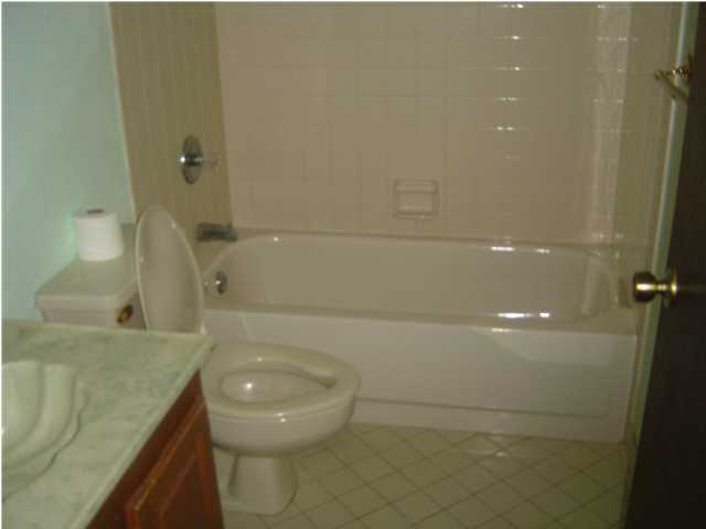 2518 Valley Road Navarre, FL 32566 - Photo 5 of 8 a bathroom with a granite countertop toilet and a sink