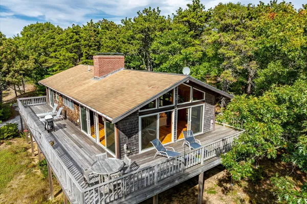 an aerial view of a house with a yard and balcony