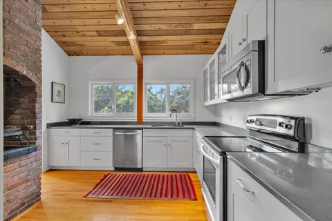 a kitchen with a sink stove and cabinets