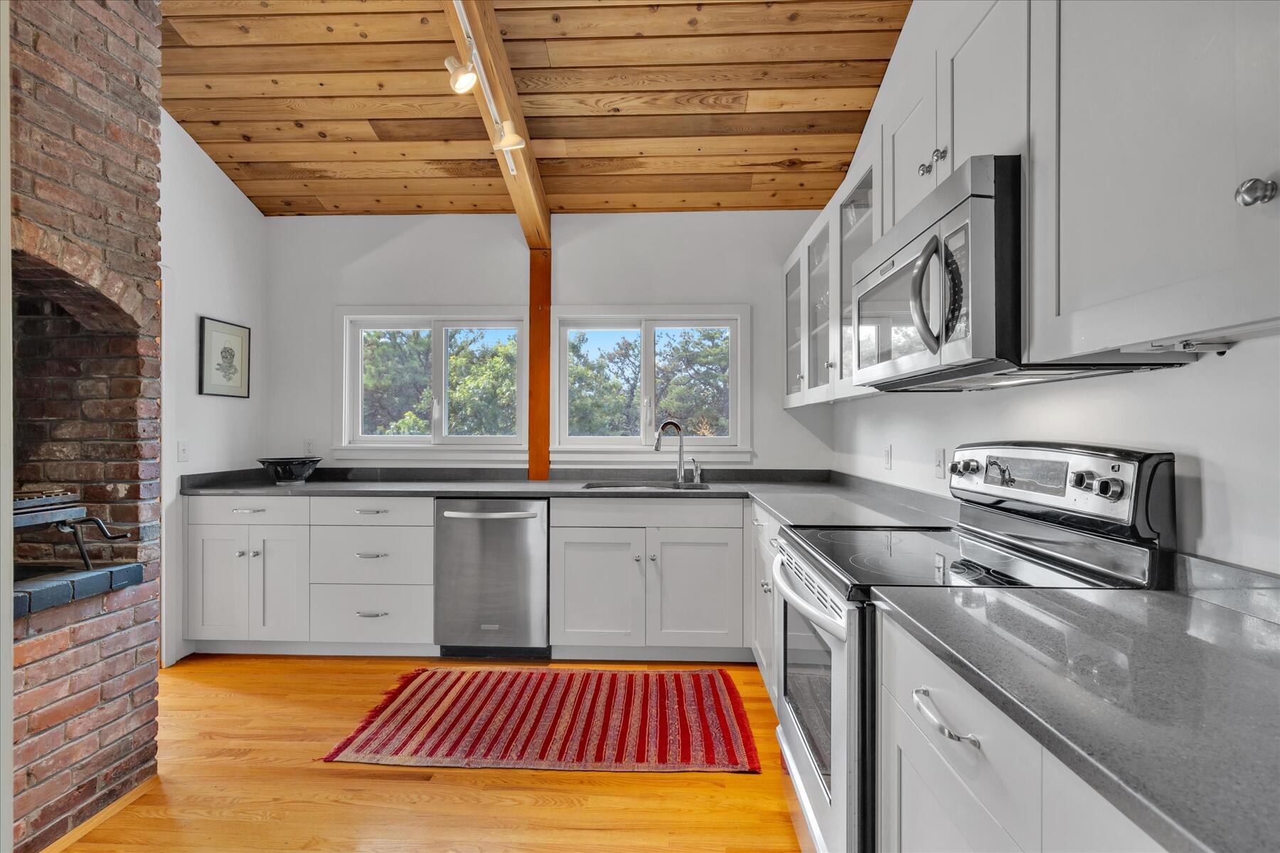 19 Avery Way Truro, MA 02666 - Photo 13 of 50 a kitchen with a sink stove and cabinets