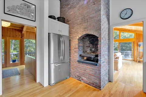 a view of a hallway with wooden floor and furniture