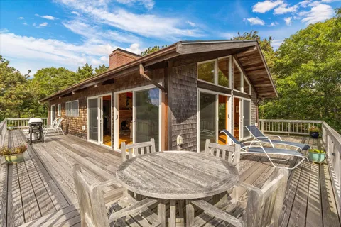 a view of balcony with wooden floor and fence