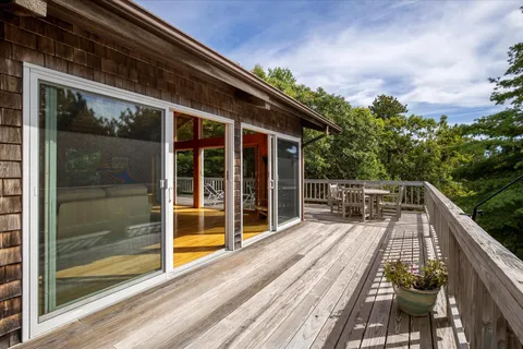 a view of balcony with wooden floor and fence