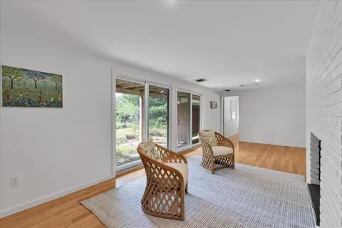 a very nice looking room with a wooden floor and furniture