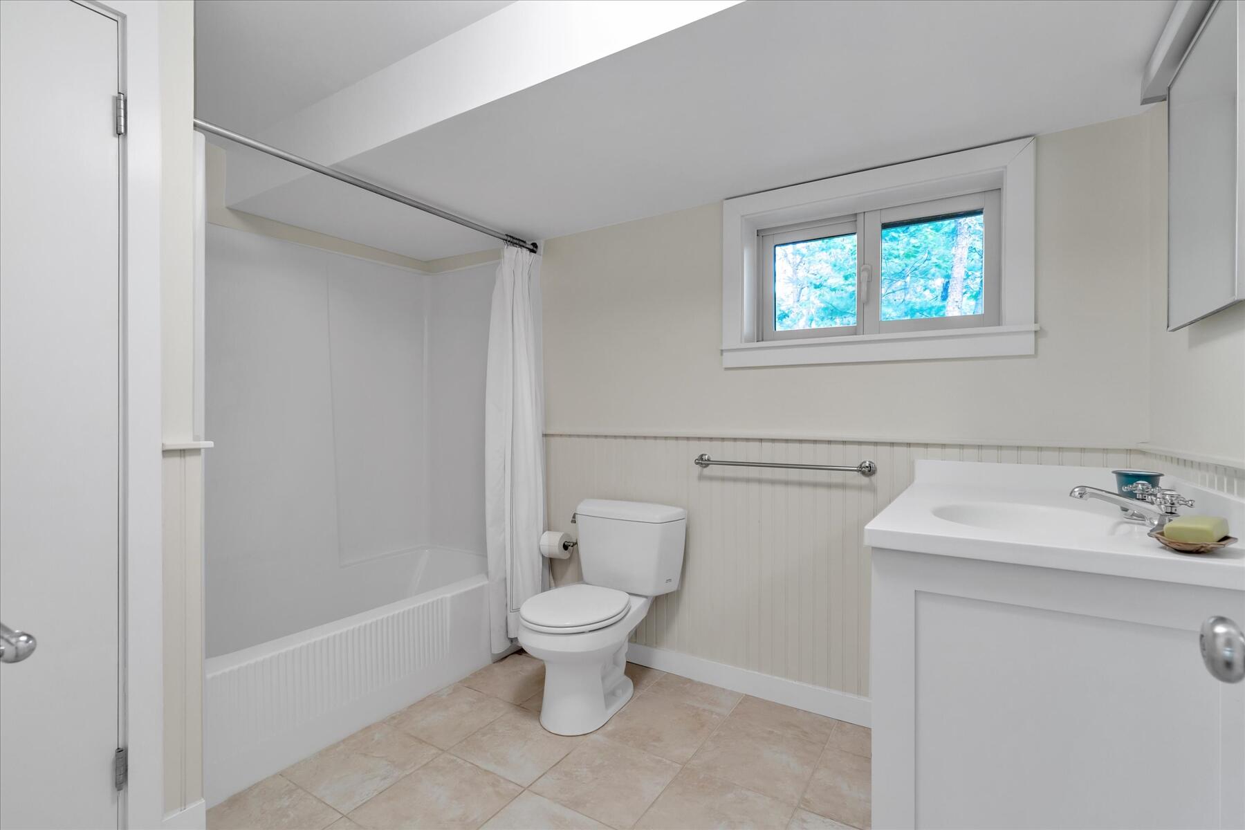 19 Avery Way Truro, MA 02666 - Photo 38 of 50 a bathroom with a toilet sink and mirror