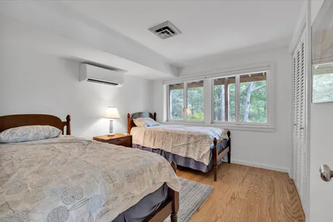 a bedroom with two beds and a walk in closet