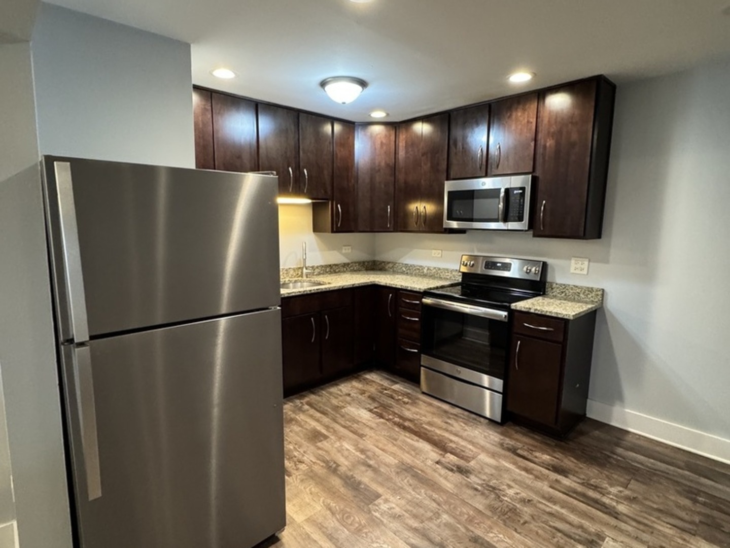1443 Homestead Road, Unit 2NW La Grange Park, IL 60526 - Photo 7 of 13 a kitchen with stainless steel appliances granite countertop a refrigerator and a stove top oven