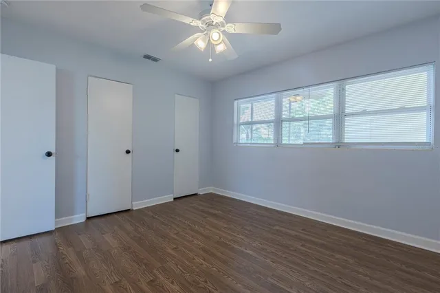 a bedroom with bed and a window
