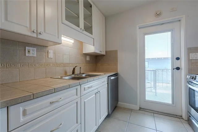 a kitchen with a sink cabinets and window
