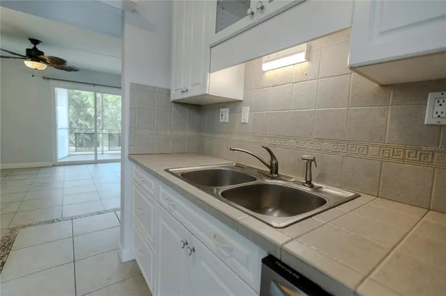 a bedroom with a large bed and a potted plant