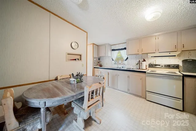 a kitchen with a table chairs sink and cabinets