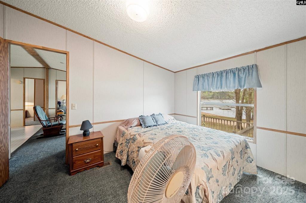 2342 Beaver Creek Road Camden, SC 29020 - Photo 15 of 26 a bedroom with a bed and a couch