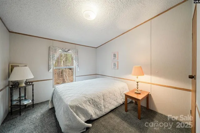a bedroom with a bed and a lamp on table
