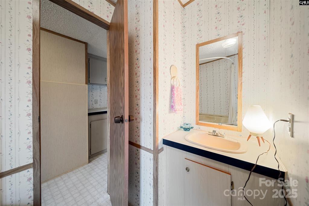 2342 Beaver Creek Road Camden, SC 29020 - Photo 20 of 26 a bathroom with a sink and a mirror