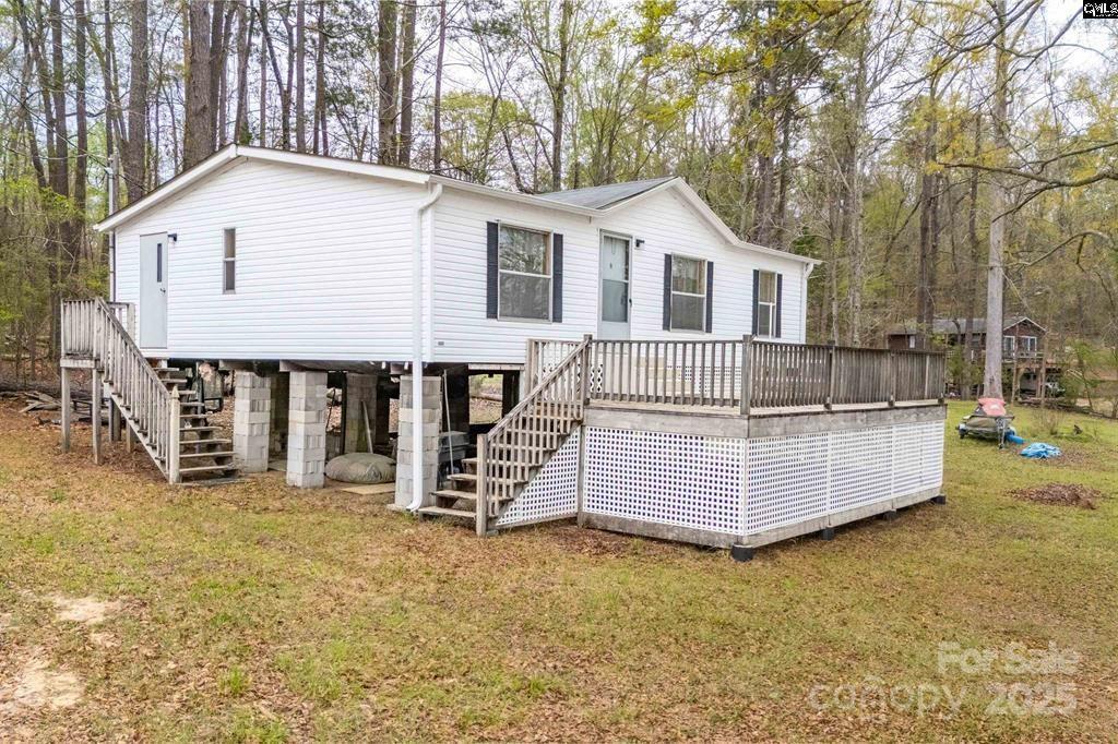 2342 Beaver Creek Road Camden, SC 29020 - Photo 3 of 26 a front view of a house with a yard and garage