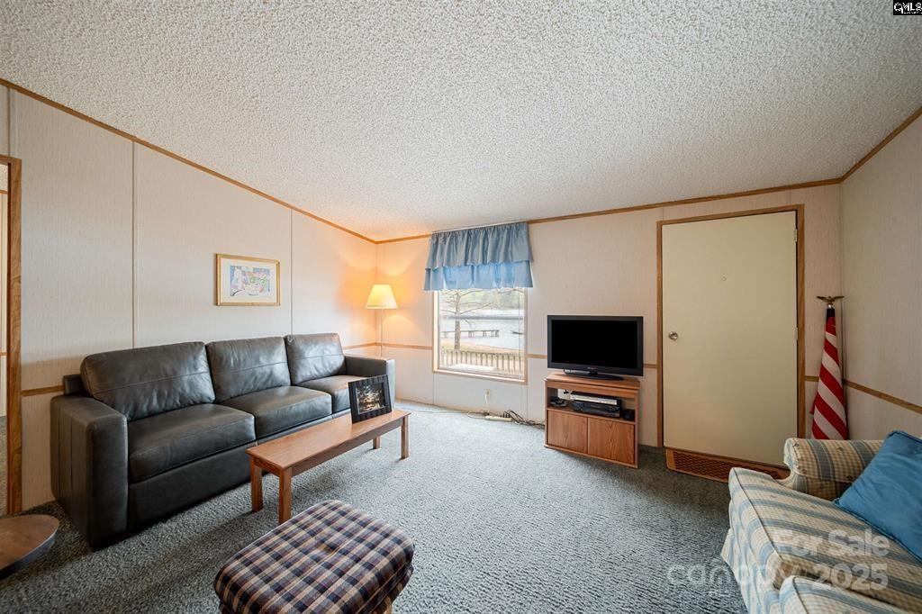 2342 Beaver Creek Road Camden, SC 29020 - Photo 5 of 26 a living room with furniture and a flat screen tv