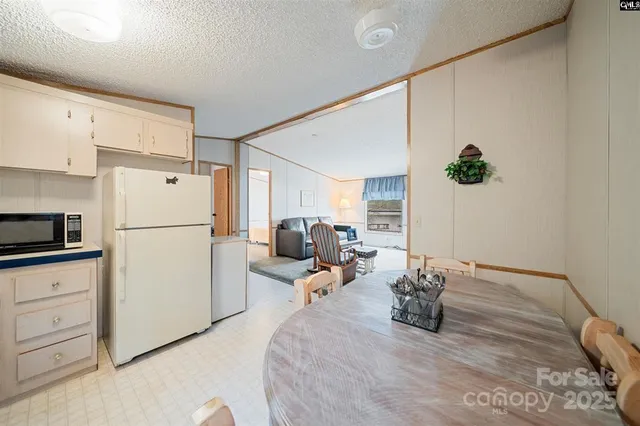 a bed room with a bed and a refrigerator