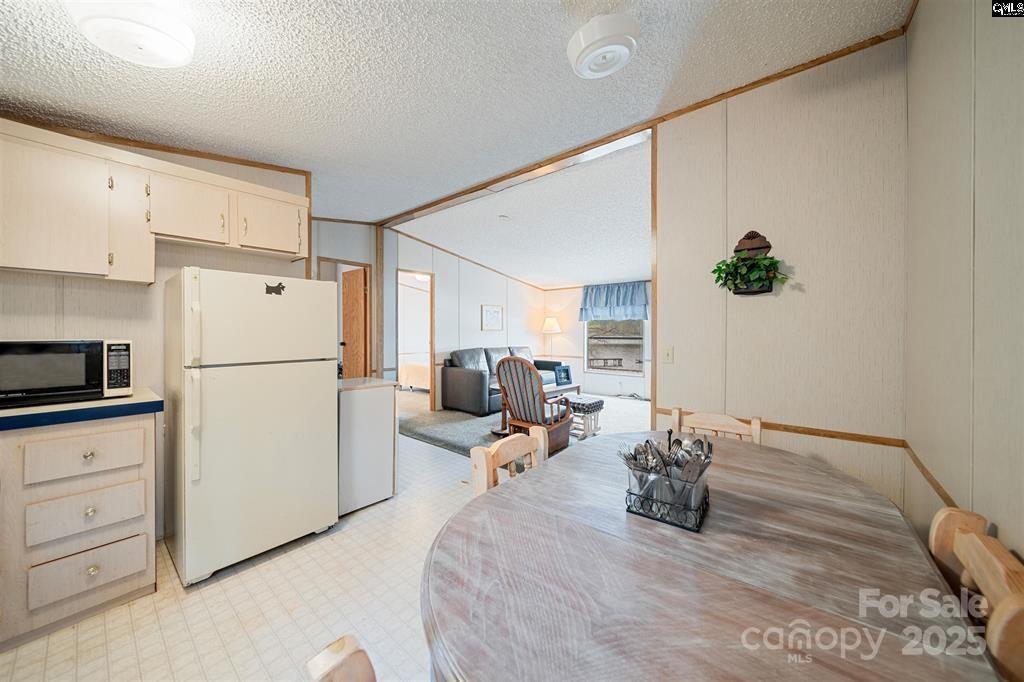 2342 Beaver Creek Road Camden, SC 29020 - Photo 10 of 26 a bed room with a bed and a refrigerator