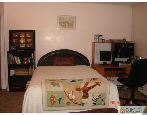 8501 Hana Road Edison, NJ 08817 - Photo 4 of 10 a bedroom with a bed and wooden floor