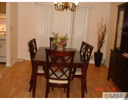 8501 Hana Road Edison, NJ 08817 - Photo 6 of 10 a dining room with furniture and a rug