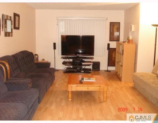 8501 Hana Road Edison, NJ 08817 - Photo 7 of 10 a living room with furniture and a flat screen tv