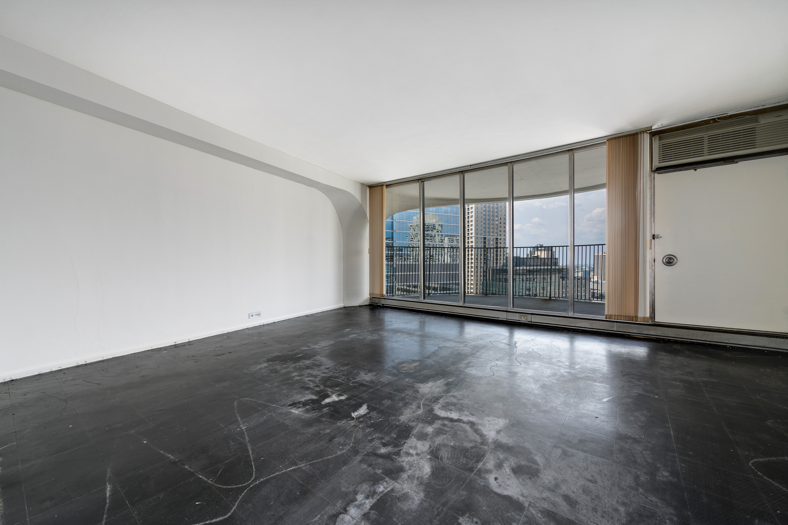300 North State Street, Unit 3128 Chicago, IL 60654 - Photo 2 of 20 an empty room with wooden floor and windows