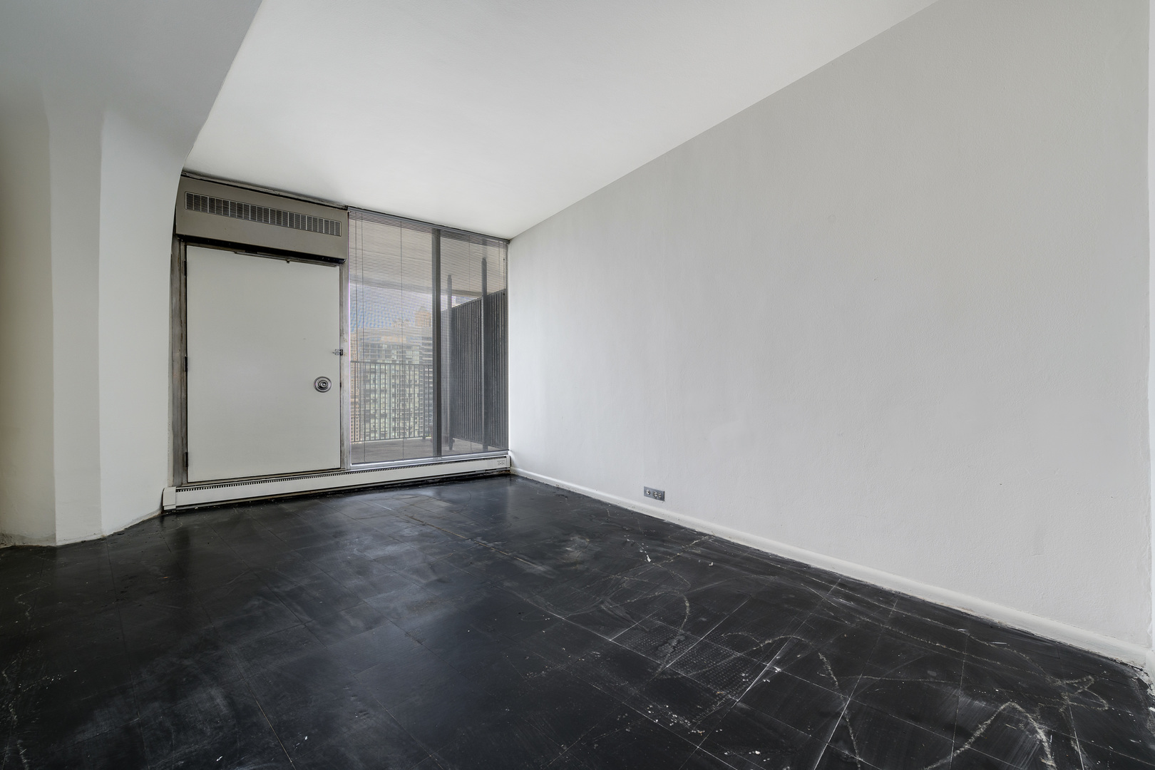 300 North State Street, Unit 3128 Chicago, IL 60654 - Photo 9 of 20 an empty room with wooden floor and closet
