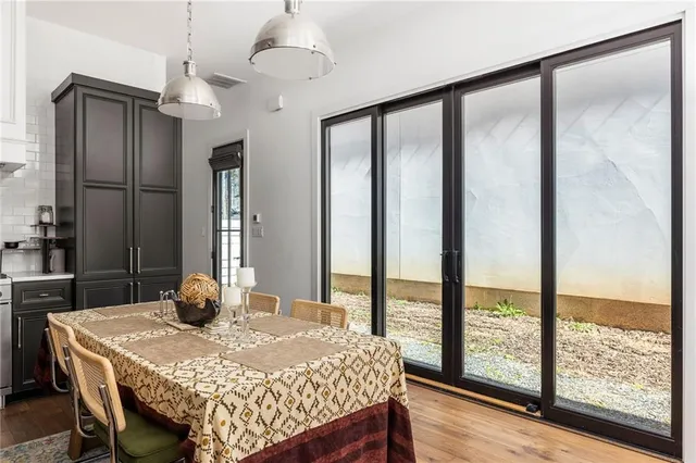 a bedroom with a bed a desk and chair with wooden floor