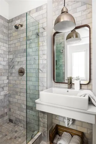 a bathroom with a sink a window and mirror