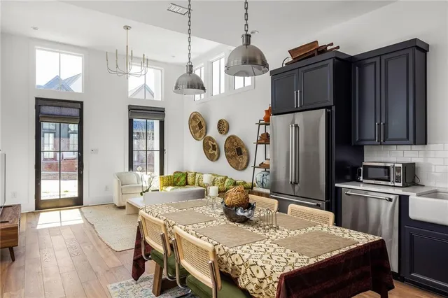 a bedroom with a bed and large windows