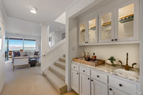 a kitchen with granite countertop a white cabinets and sink