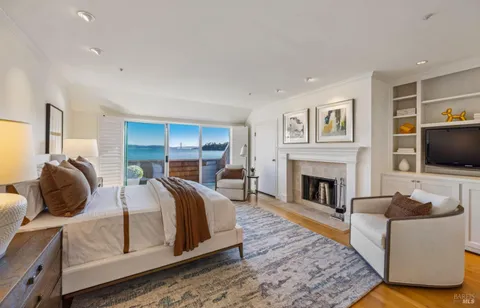 a bedroom with a bed and a fireplace