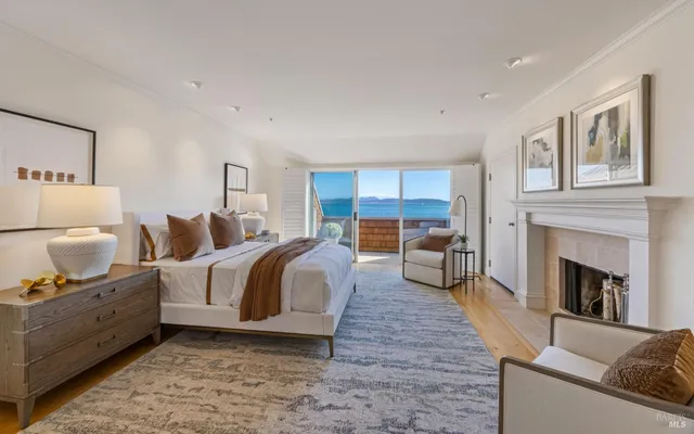 a spacious bedroom with a balcony a bed and a couch