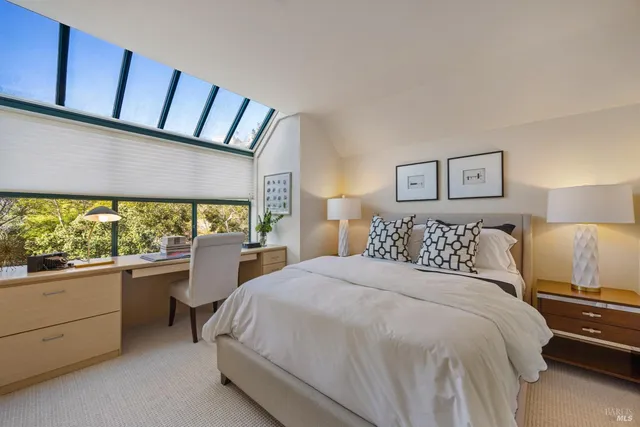 a bedroom with a large bed and a large window