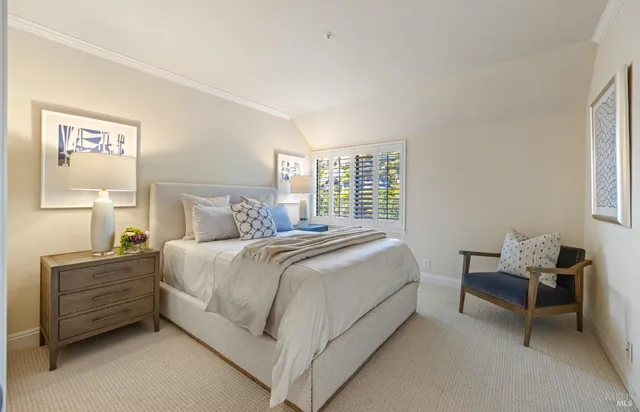 a bedroom with a large bed and a large window