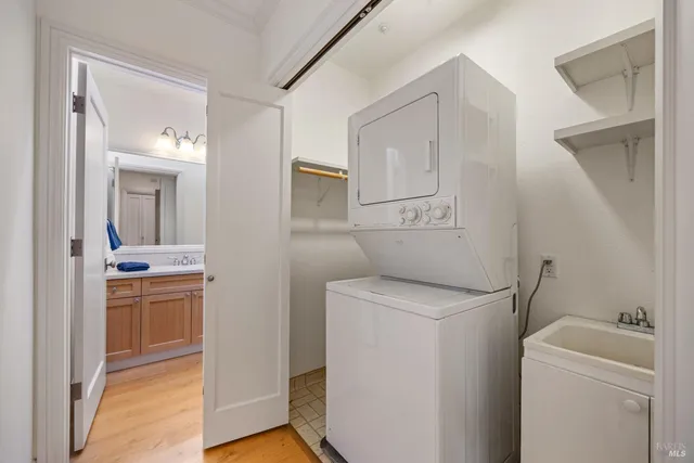 a view of a storage and utility room with washer and dryer