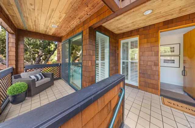 a view of a couches in the patio with a backyard