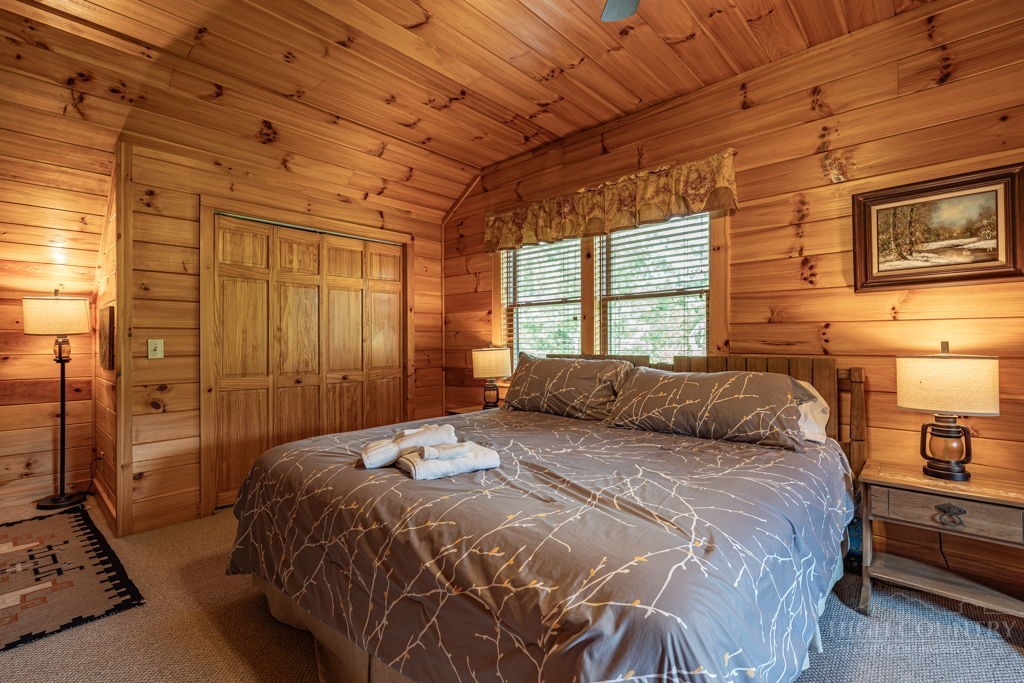 197 Woodby Ridge Road Vilas, NC 28692 - Photo 26 of 45 a bedroom with a bed and a dresser next to a window