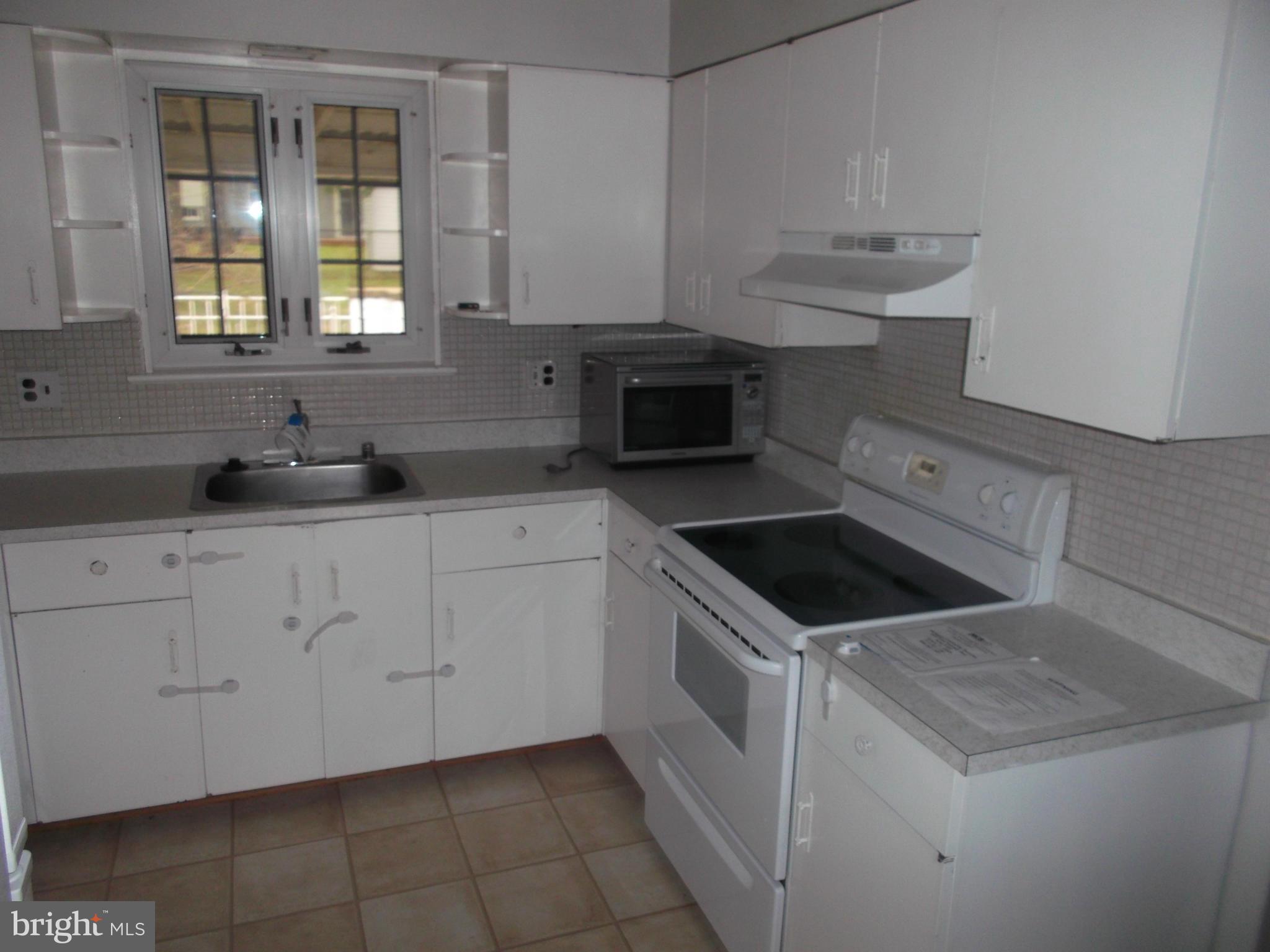 7422 Chatham Street Springfield, VA 22151 - Photo 12 of 30 a kitchen with white cabinets sink and appliances