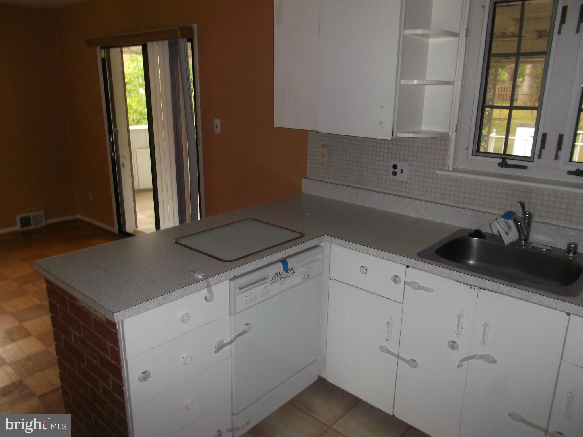 7422 Chatham Street Springfield, VA 22151 - Photo 13 of 30 a kitchen with a sink cabinets and window